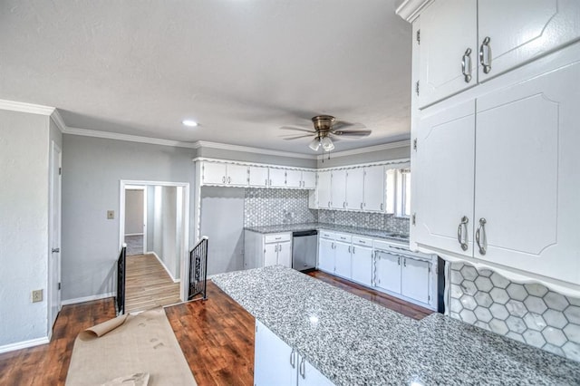 kitchen featuring tasteful backsplash, white cabinets, and stainless steel dishwasher