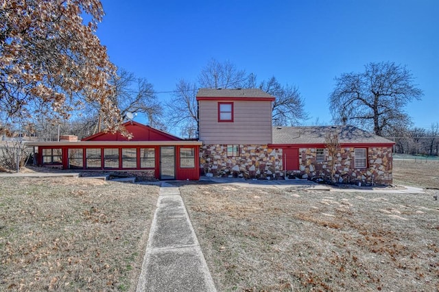 back of property with a sunroom