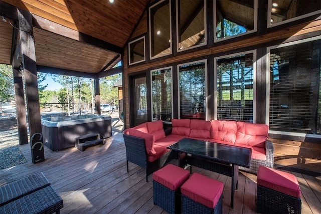 wooden deck with an outdoor living space and a hot tub