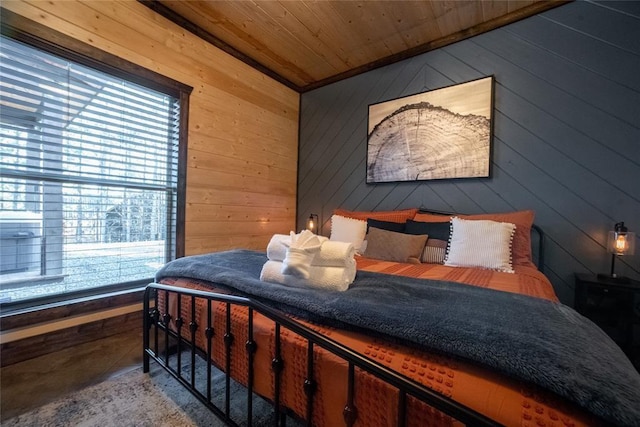 bedroom with wood ceiling and wood walls