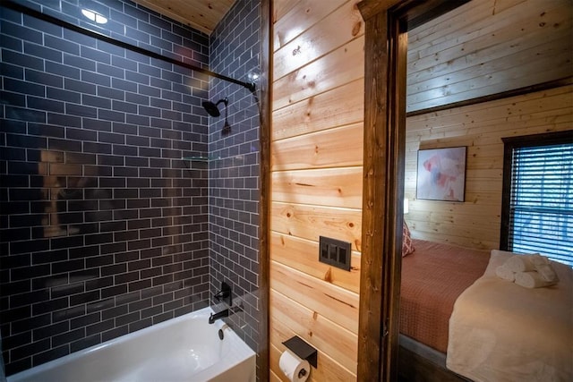 bathroom with wooden walls and tiled shower / bath combo