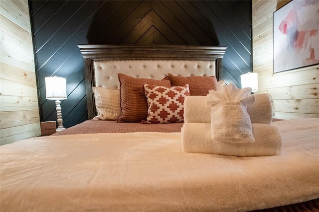 bedroom featuring wooden walls