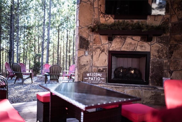 living room with a stone fireplace and hardwood / wood-style floors