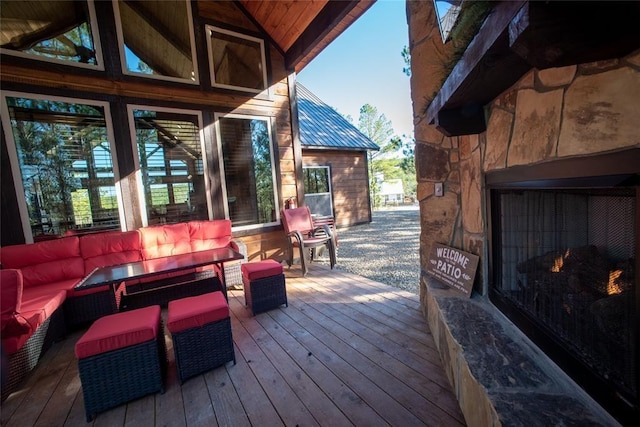 wooden terrace with an outdoor living space