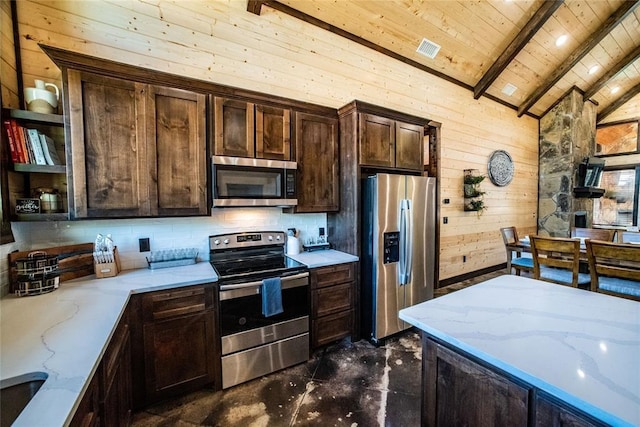 kitchen with wooden walls, lofted ceiling with beams, stainless steel appliances, light stone countertops, and wood ceiling