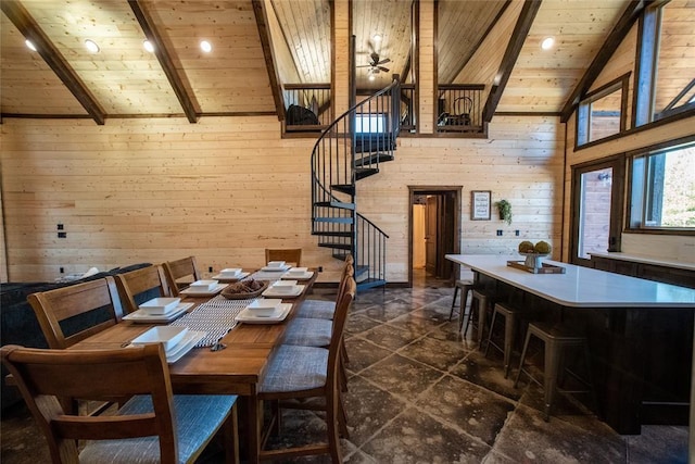 dining area with wooden walls, beamed ceiling, high vaulted ceiling, and wooden ceiling