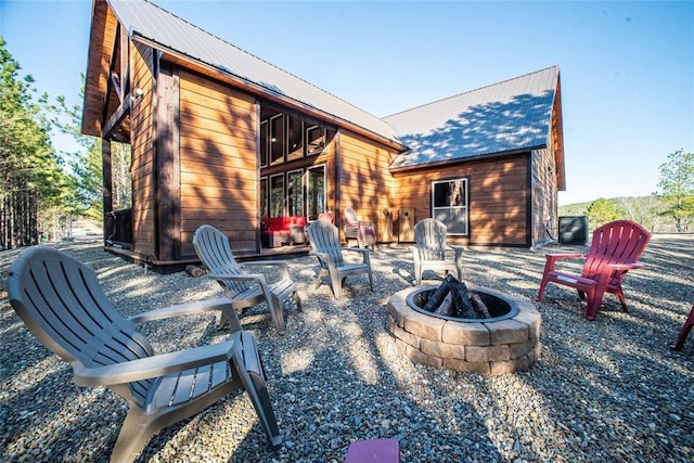 view of patio featuring central AC unit and a fire pit