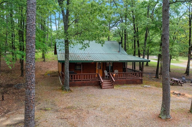 log home featuring a porch