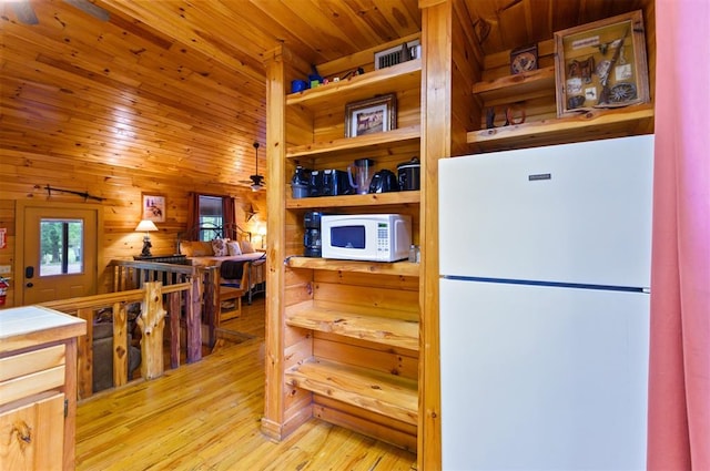 kitchen with wood walls, white appliances, wooden ceiling, ceiling fan, and light wood-type flooring