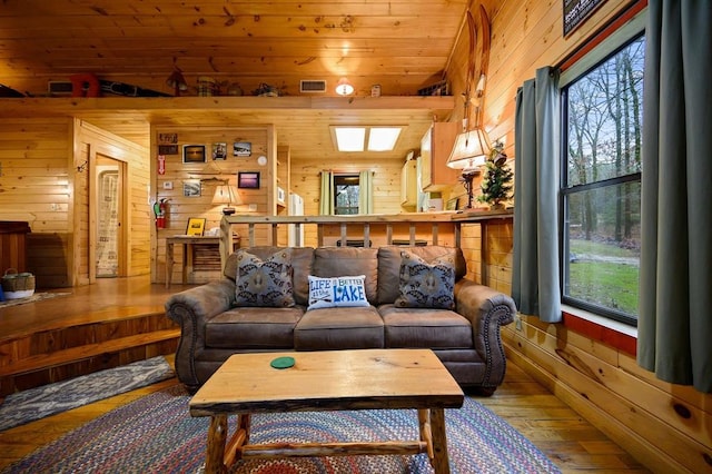 living room with a wealth of natural light and wood walls