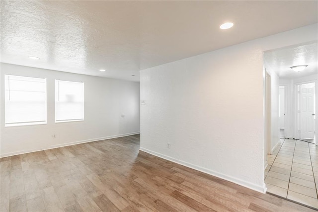 unfurnished room with light hardwood / wood-style floors