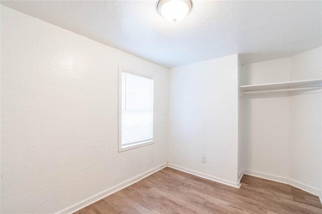 unfurnished bedroom featuring a closet and wood-type flooring