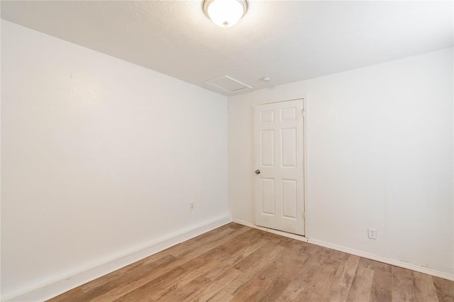 empty room with light hardwood / wood-style flooring