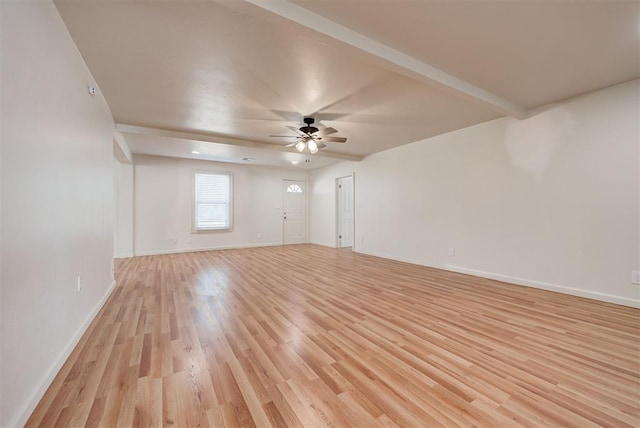 empty room with ceiling fan, beam ceiling, and light hardwood / wood-style flooring