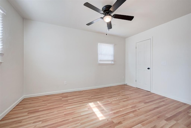 spare room with light wood-type flooring and ceiling fan