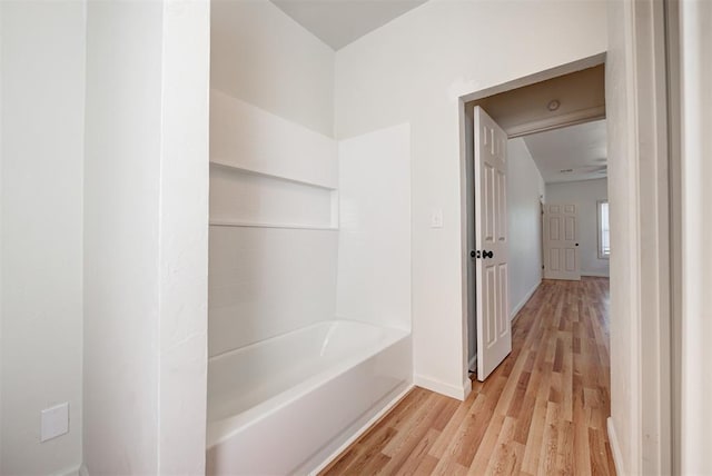 bathroom featuring hardwood / wood-style floors and a tub