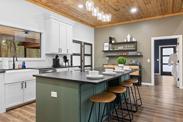 kitchen with white cabinets, a center island, and wooden ceiling