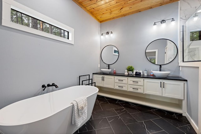 bathroom with vanity, a tub to relax in, and wooden ceiling