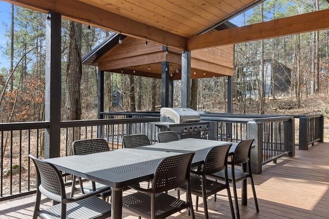 sunroom / solarium featuring wooden ceiling, a wealth of natural light, and vaulted ceiling