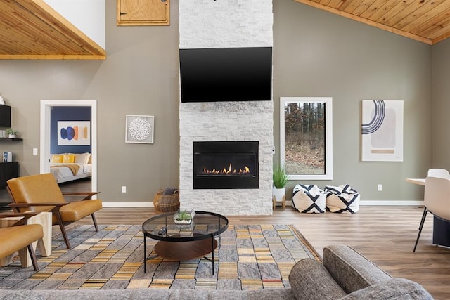 living room with a fireplace, wood-type flooring, high vaulted ceiling, and wood ceiling