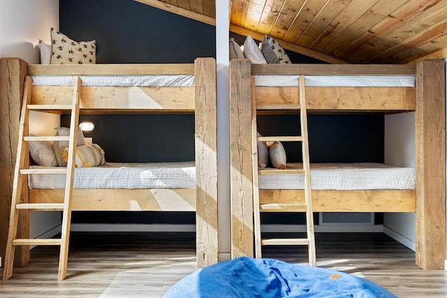 unfurnished bedroom featuring hardwood / wood-style floors, wood ceiling, and vaulted ceiling