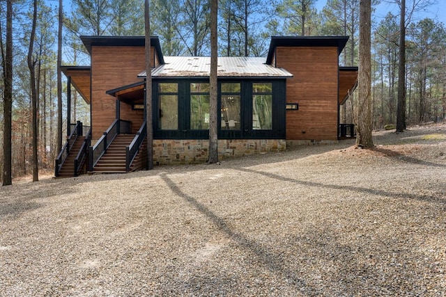 back of house featuring a sunroom and central air condition unit