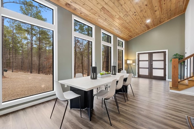 sunroom / solarium featuring french doors, wooden ceiling, and lofted ceiling