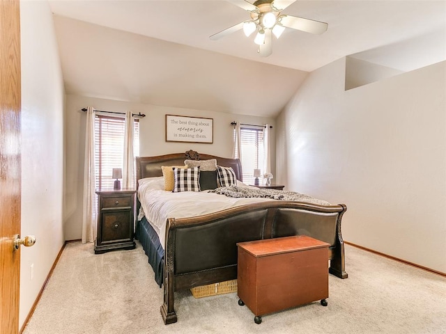 bedroom with ceiling fan, light carpet, and vaulted ceiling