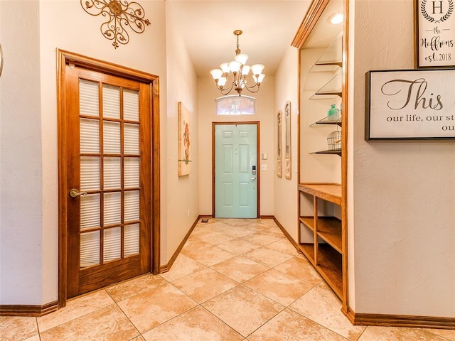 foyer entrance with light tile patterned floors and an inviting chandelier