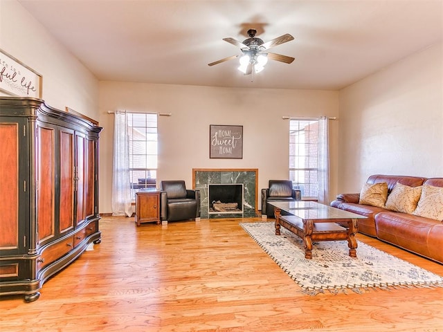 living room with ceiling fan and light hardwood / wood-style floors