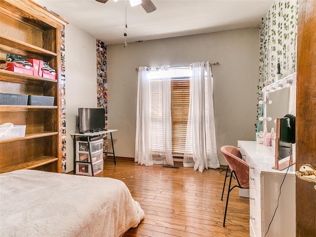 bedroom with ceiling fan and hardwood / wood-style flooring