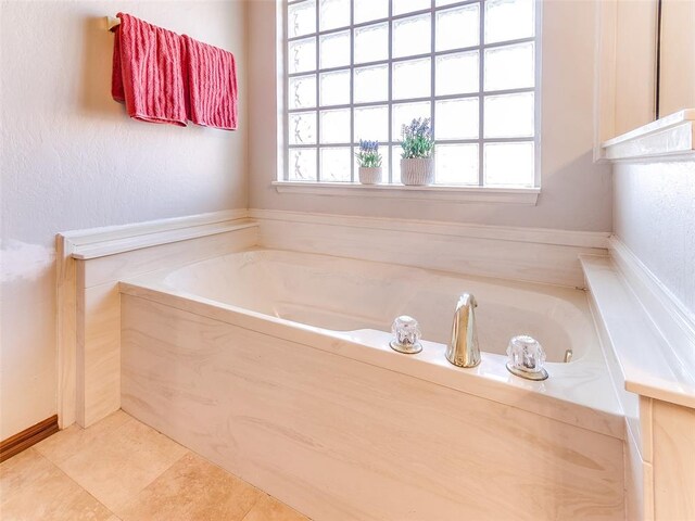 bathroom featuring tile patterned floors and a bathtub