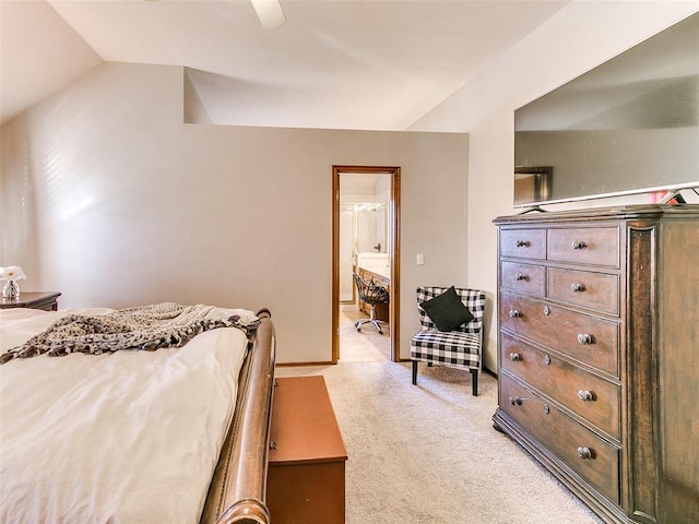 carpeted bedroom featuring ensuite bathroom, ceiling fan, and vaulted ceiling