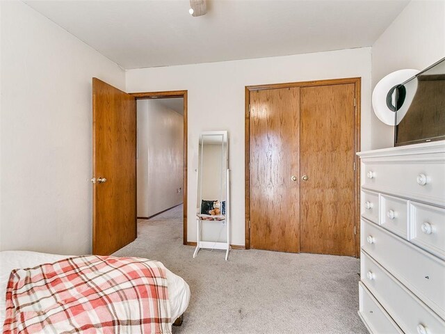 carpeted bedroom with a closet