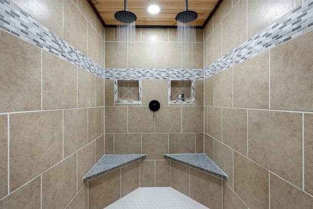 bathroom featuring a tile shower and wooden ceiling