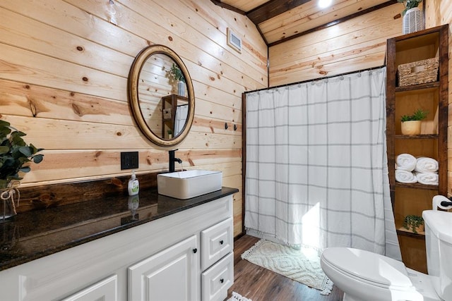 bathroom with hardwood / wood-style floors, wood walls, toilet, and wooden ceiling