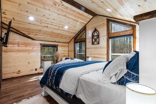 bedroom featuring hardwood / wood-style flooring, multiple windows, and wooden walls