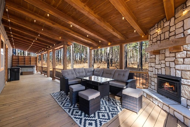 deck featuring an outdoor living space with a fireplace