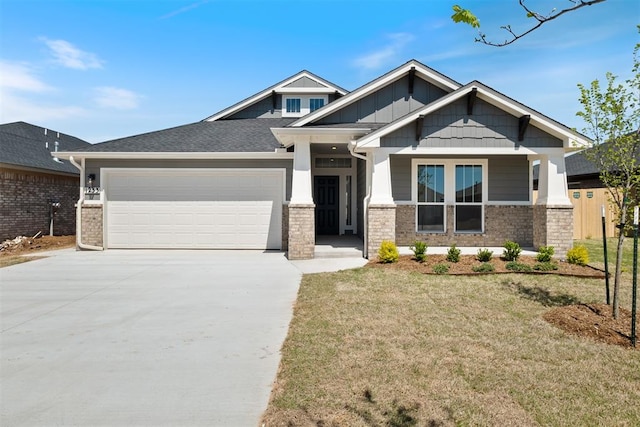 craftsman-style house featuring covered porch, a garage, and a front lawn