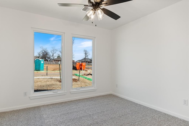 carpeted spare room featuring ceiling fan