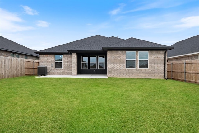 back of property with a yard, a patio, and central AC unit