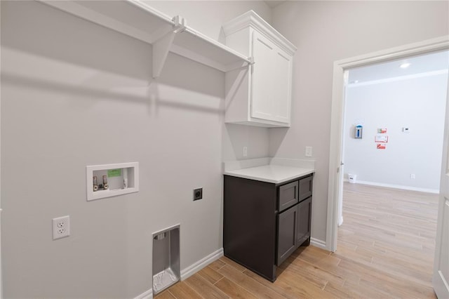 laundry room with washer hookup, electric dryer hookup, and cabinets