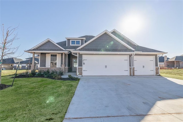 craftsman inspired home with a garage and a front lawn