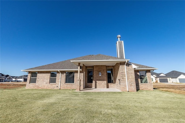 back of property with a patio area and a yard