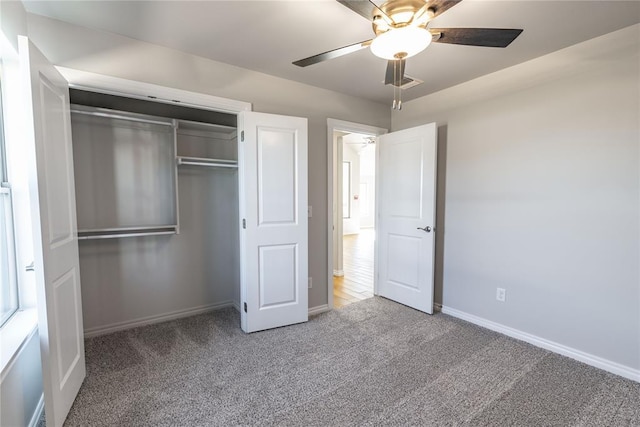 unfurnished bedroom featuring carpet flooring, a closet, and ceiling fan