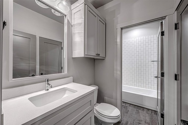 full bathroom featuring vanity, toilet, and tiled shower / bath combo