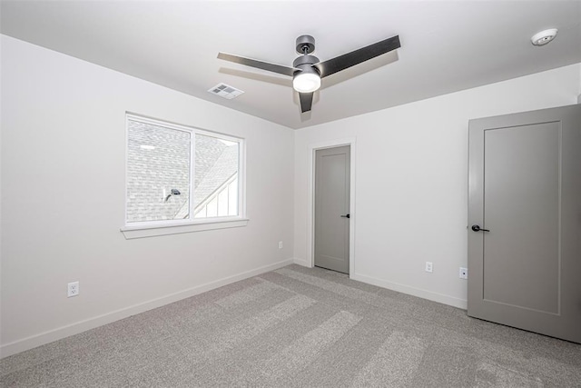 unfurnished room with ceiling fan and light colored carpet