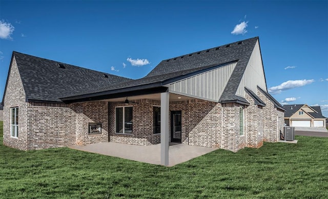 back of property featuring a lawn, central AC, ceiling fan, and a patio