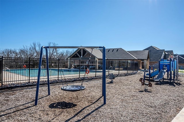 view of jungle gym featuring a community pool