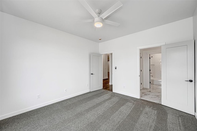 unfurnished bedroom with ceiling fan, ensuite bathroom, and light colored carpet